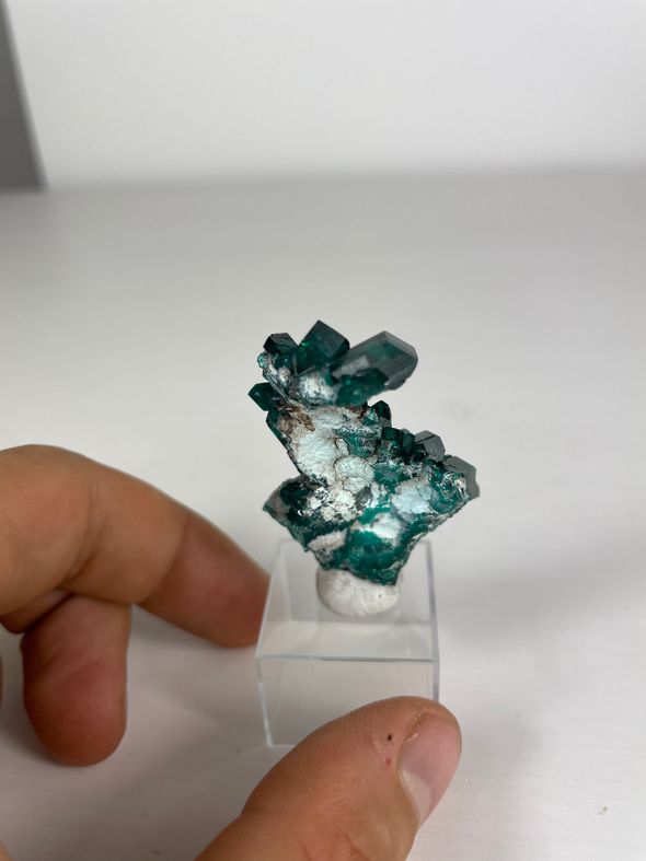 dioptase stone held in a hand